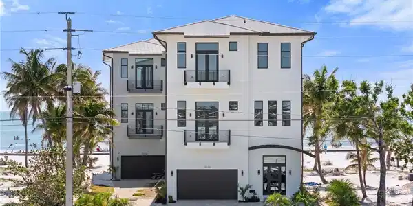 Image 3: Contemporary home with stucco siding, decorative driveway, and a garageVirtually Enhanced