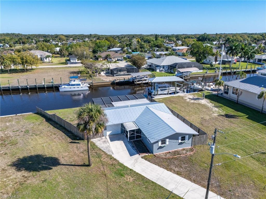Image 1: Aerial view of residential area featuring a large body of water