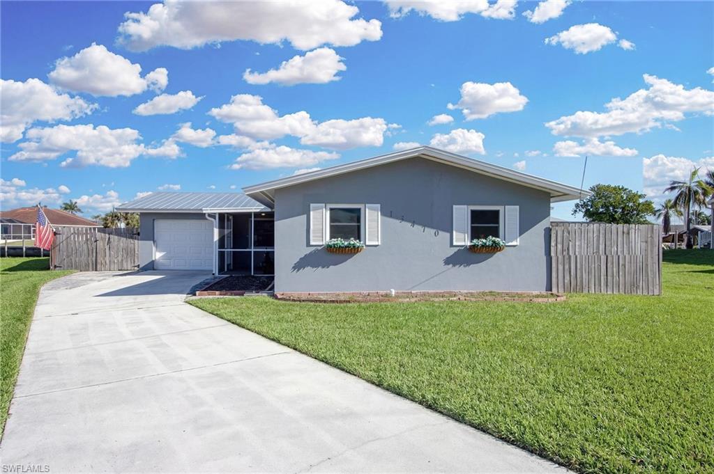 Image 3: Ranch-style home featuring driveway, stucco siding, and a garage