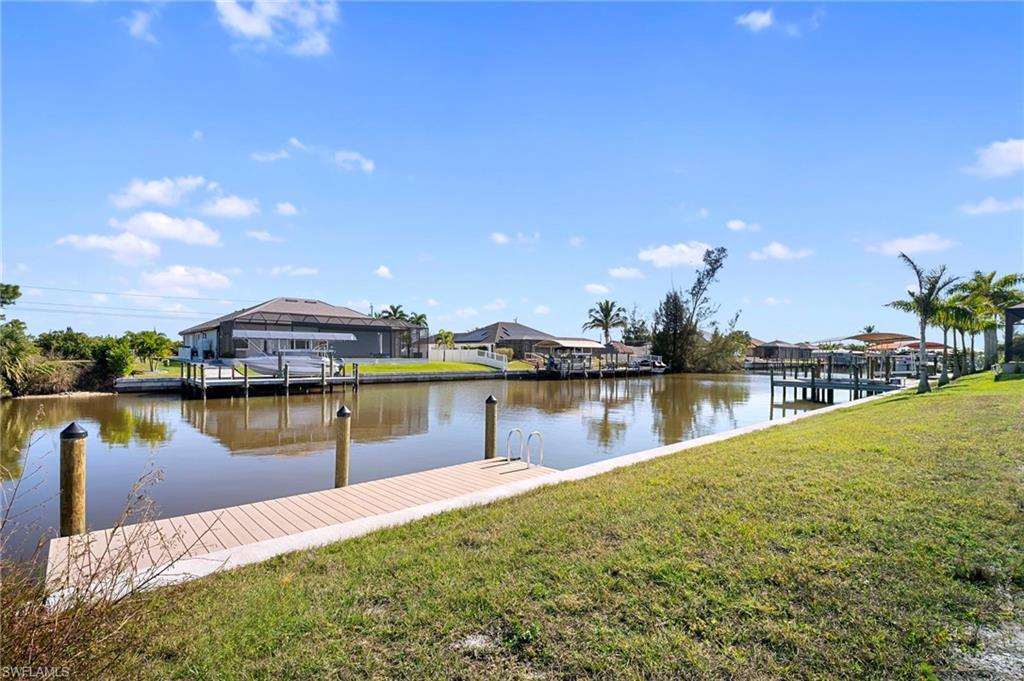 Image 1: Dock area with a lawn, a water view, and a residential view