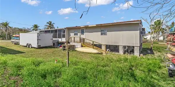 Image 2: Back of house featuring a lawn