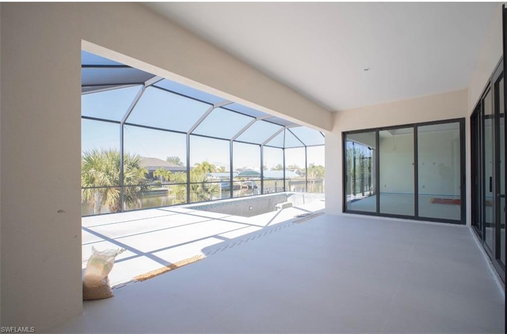 Image 3: View of patio / terrace featuring a lanai, a sunroom, an outdoor pool, and a water view