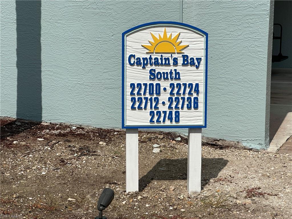 Image 2: Captain's Bay South directional signage featuring white and blue detailing with a prominent sun graphic