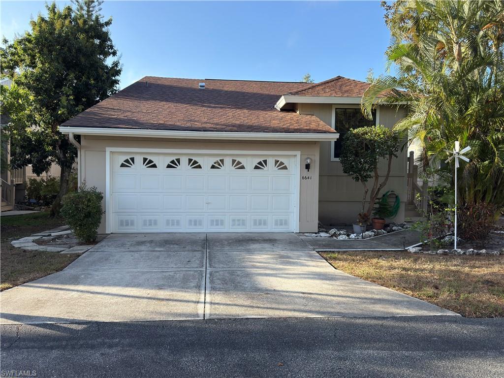 Image 1: Ranch-style house with roof with shingles, concrete driveway, and an attached garage