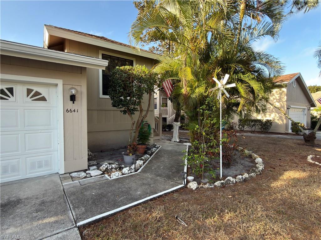 Image 2: Property entrance featuring a garage