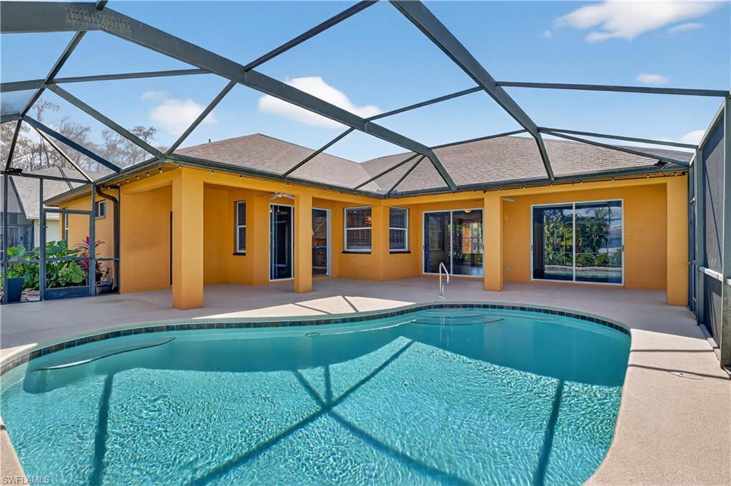 Image 1: Outdoor pool featuring a sunroom, a patio area, and a lanai