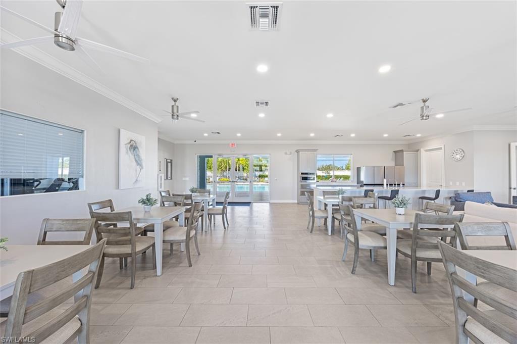 Image 3: Dining space featuring ceiling fan, recessed lighting, crown molding, and light tile patterned floors