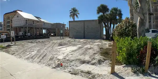 Image 2: Looking in to lot from right front side corner toward back of lot , concert wall on back lot line Sits on Estero Blvd