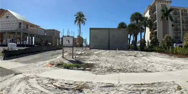 Image 4: Looking in to lot front Estero Blvd house being built on lot behind  it can be seen, small sandy road on left side of lot gives access to other lots