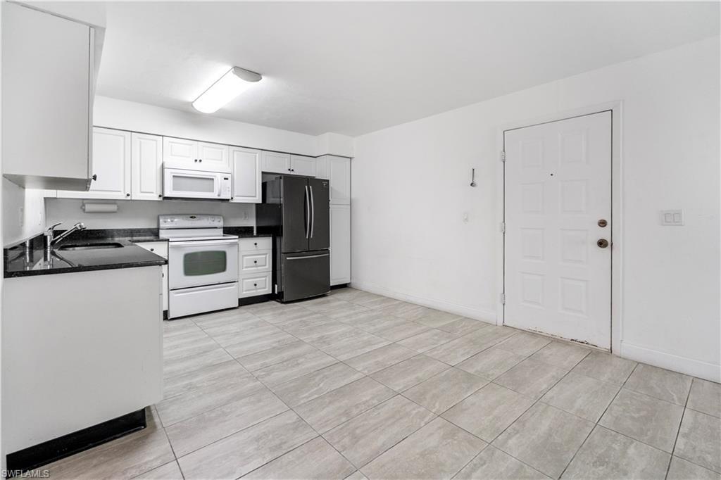 Image 4: Kitchen with white appliances and white cabinetry