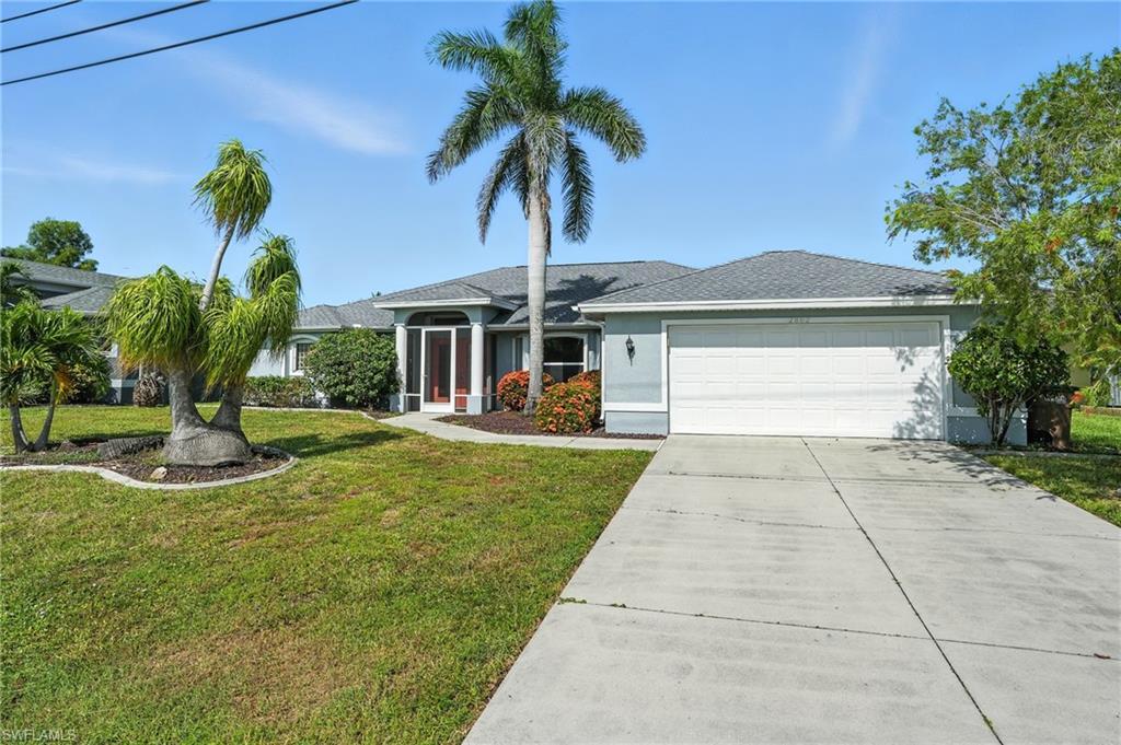 Image 2: Ranch-style home featuring concrete driveway, an attached garage, a front yard, stucco siding, and a shingled roof