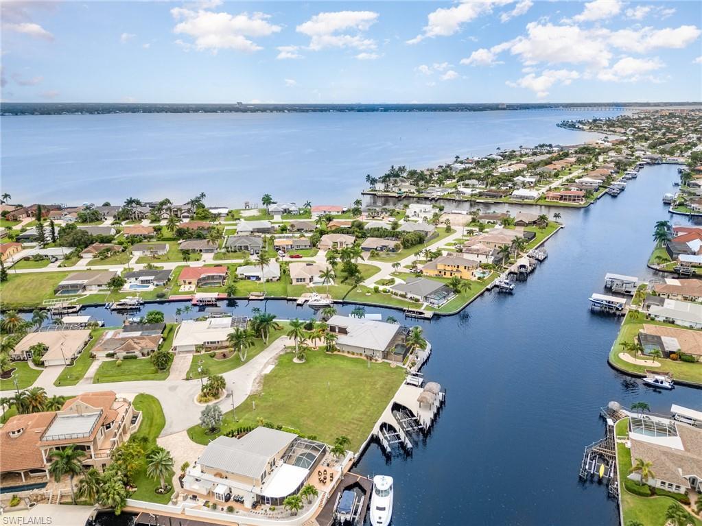 Image 2: Aerial view of residential area featuring a large body of water