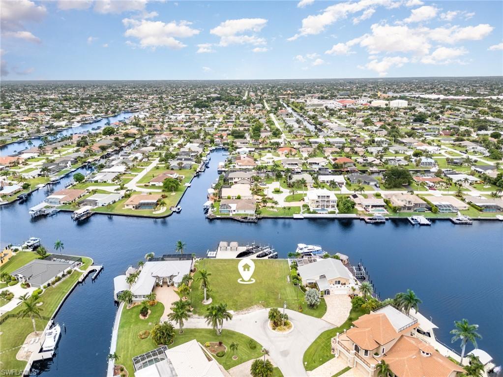 Image 3: Aerial perspective of suburban area with a large body of water