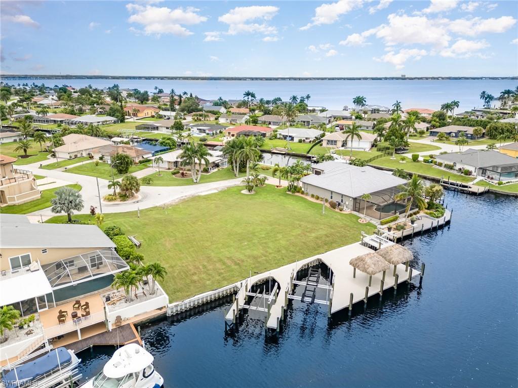 Image 4: Aerial perspective of suburban area with a large body of water