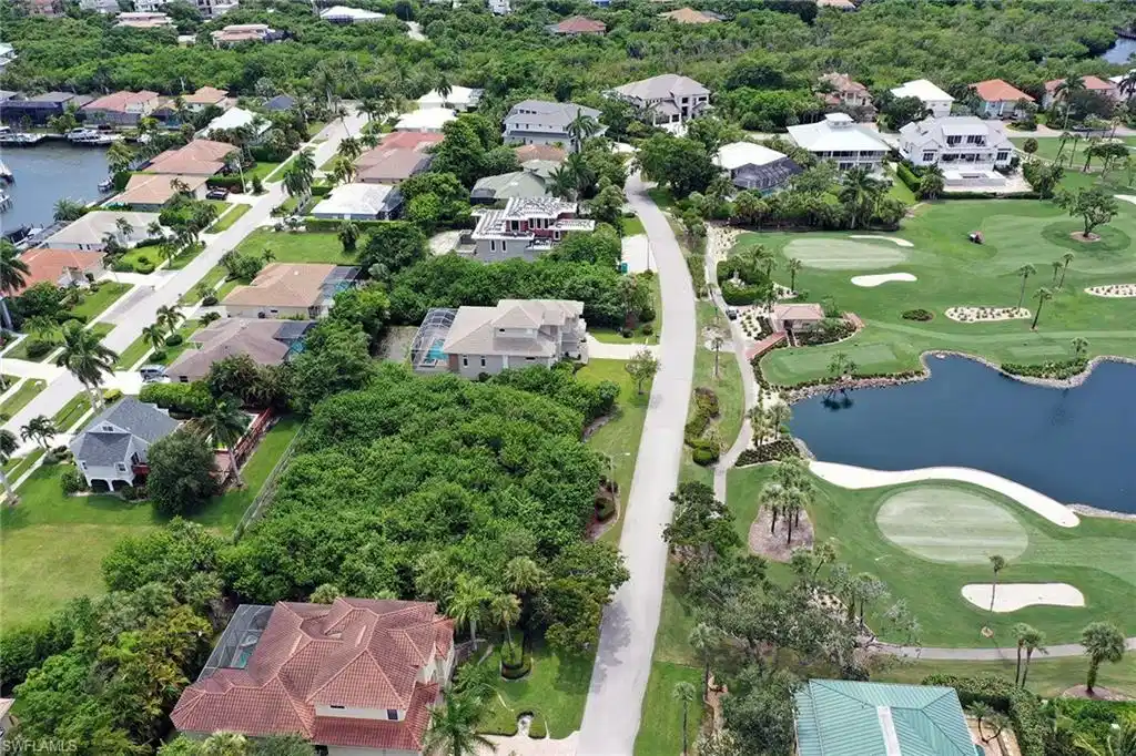 Image 1: Aerial overview of property's location with a nearby body of water and nearby suburban area