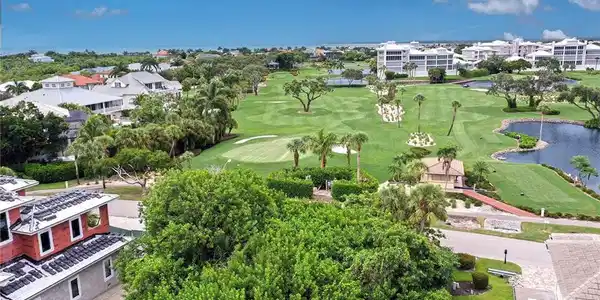 Image 4: Bird's eye view of a local golf course and a large body of water