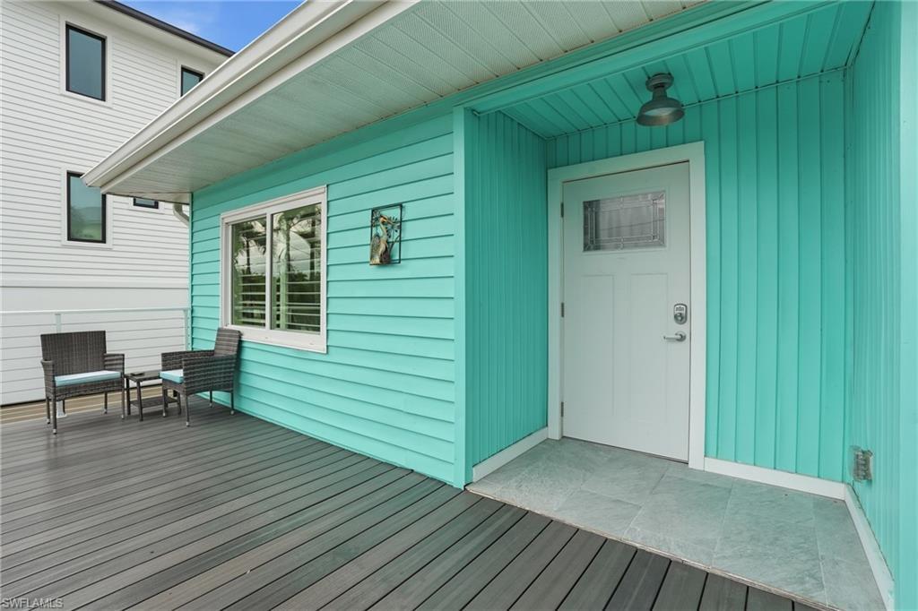 Image 4: Property entrance featuring a wooden deck - Virtually Edited Image