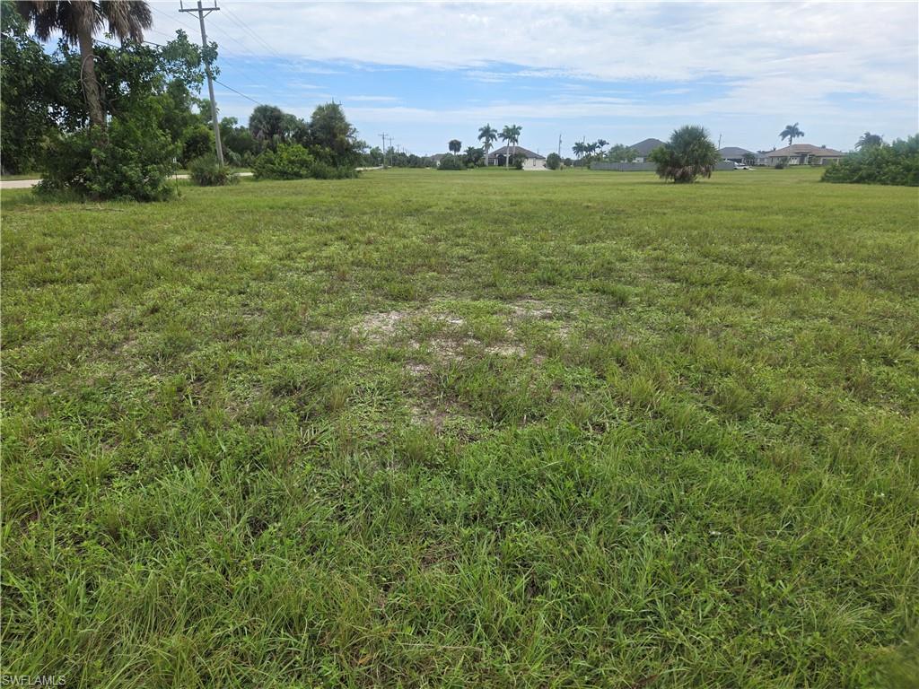 Image 2: View of green lawn featuring a rural view