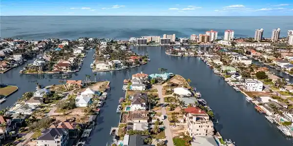 Image 3: View of property location featuring a nearby body of water and nearby suburban area