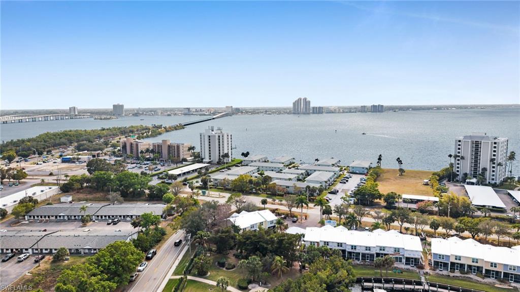 Image 2: View of urban area with a large body of water and a notable bridge