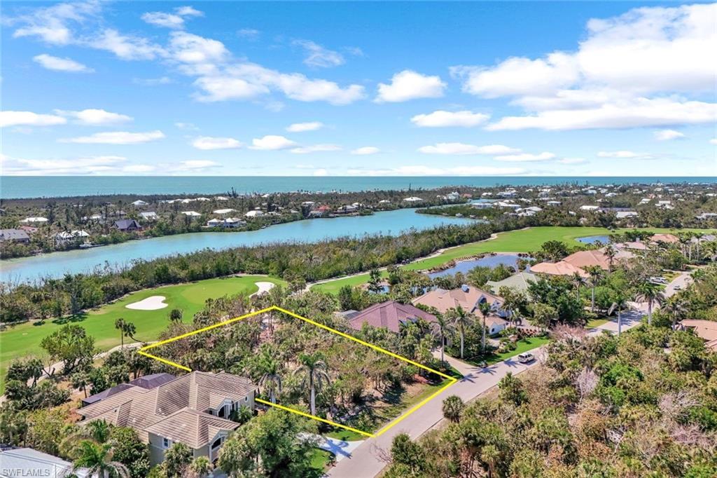 Image 1: Birds eye view of property featuring golf course view and a water view