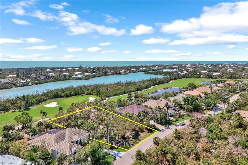 Image 1: Birds eye view of property featuring golf course view and a water view