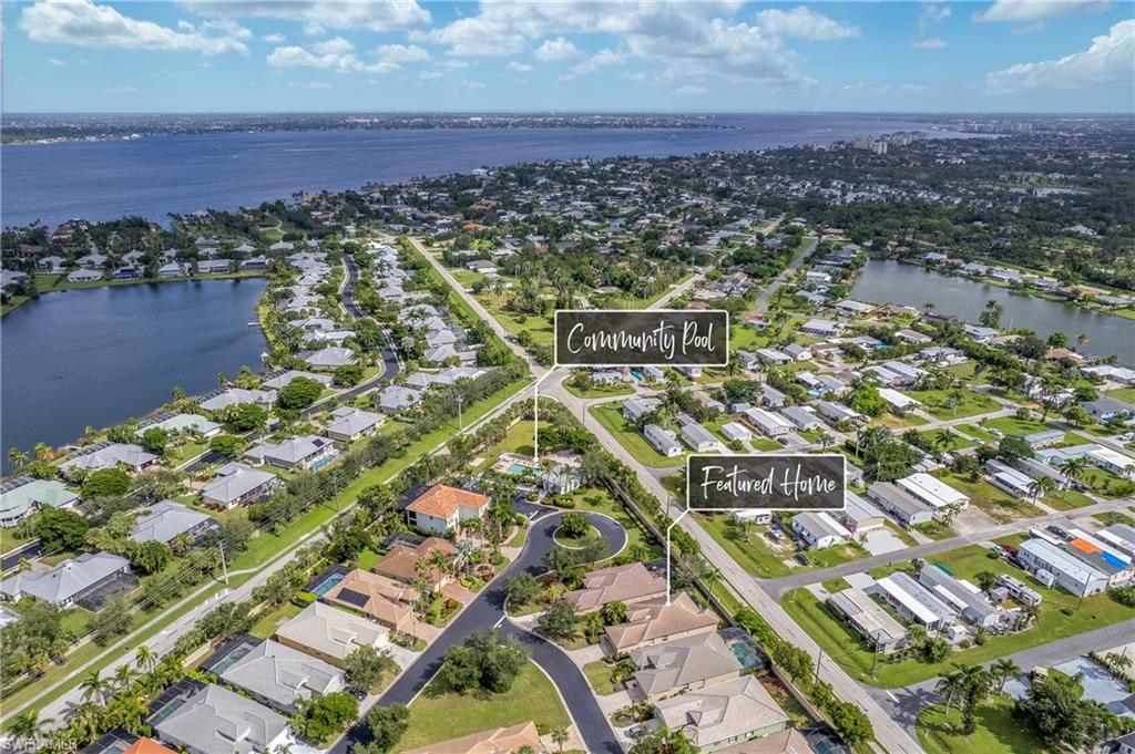 Image 2: Aerial view of the home's location with nearby Community Center with Pool.