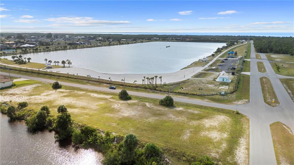 Image 2: Aerial view of property and surrounding area featuring a large body of water