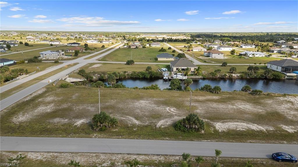 Image 4: Aerial view of residential area featuring a large body of water