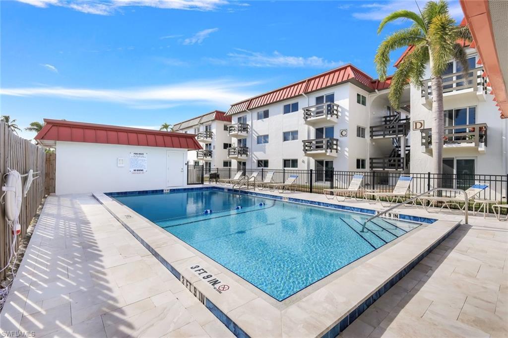 Image 3: Community pool with a patio