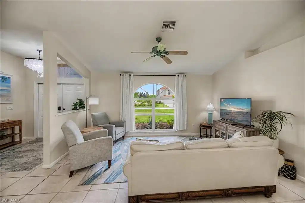 Image 1: family room looking into front entrance of home