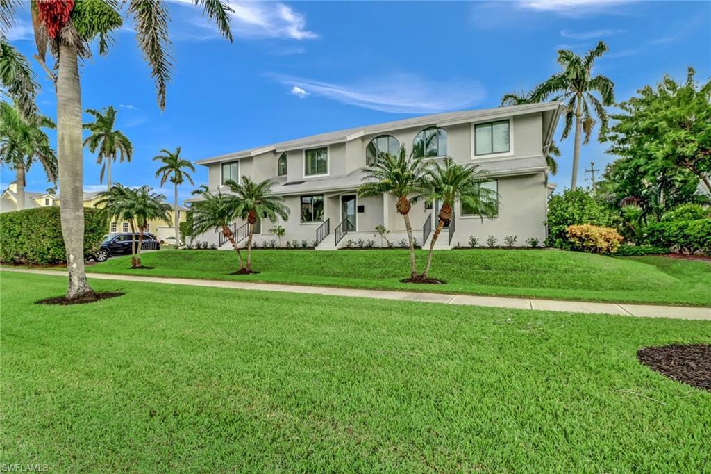Image 2: View of front of property featuring stucco siding and a front yard