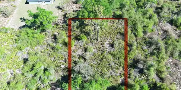 Image 4: Aerial view of property and surrounding area with property parcel outlined