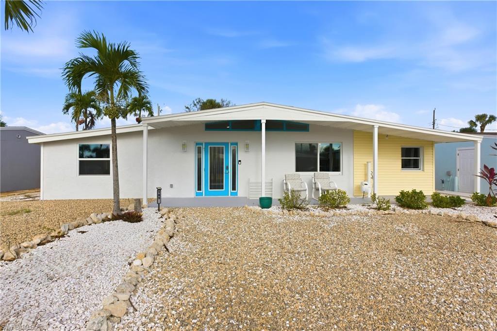 Image 1: Ranch-style home with covered porch and stucco siding