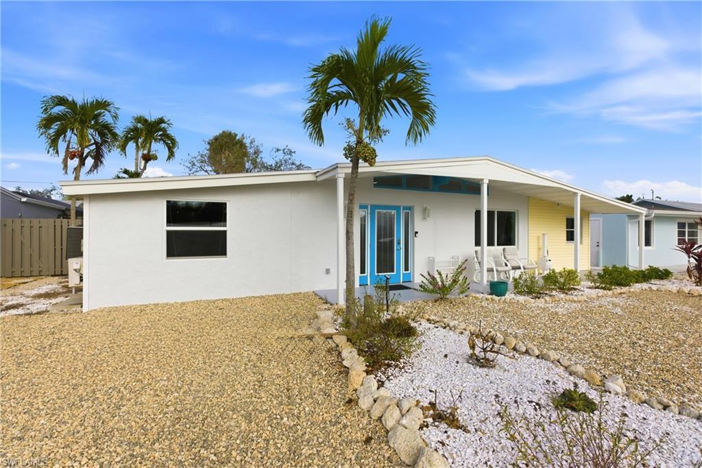 Image 3: Rear view of house featuring stucco siding