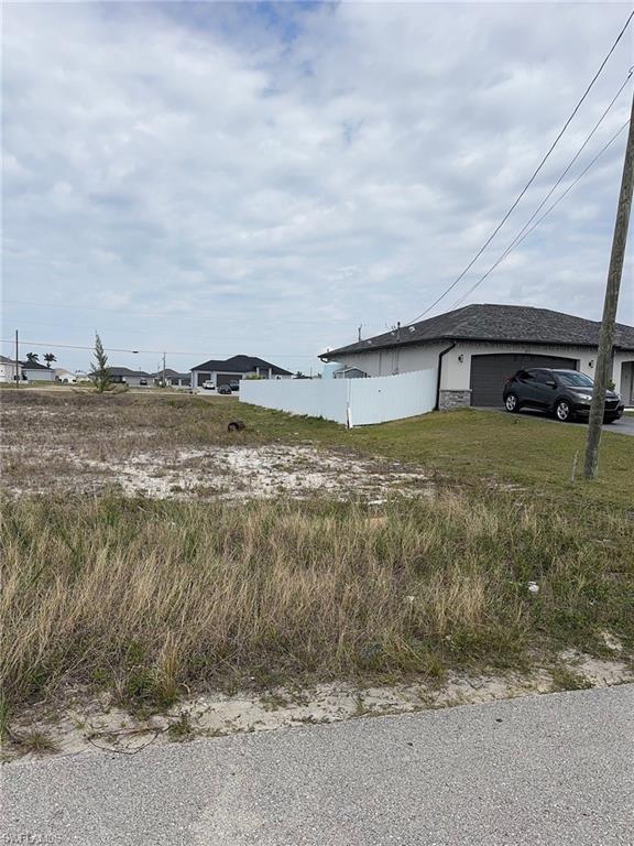 Image 2: View of yard featuring a garage and fence
