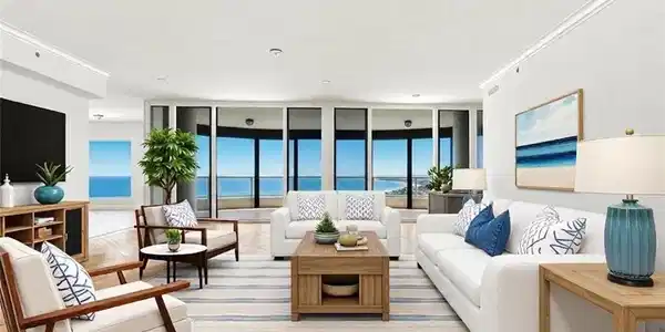 Image 2: VIRTUALLY STAGED. Spacious living area featuring expansive windows, wood-finish flooring, recessed lighting, crown molding, and a built-in entertainment console