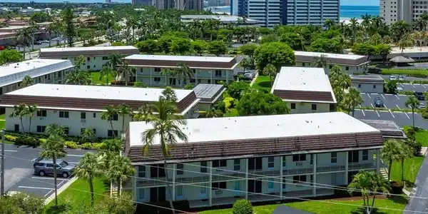 Image 3: Multi-story buildings featuring white exteriors and brown roofs