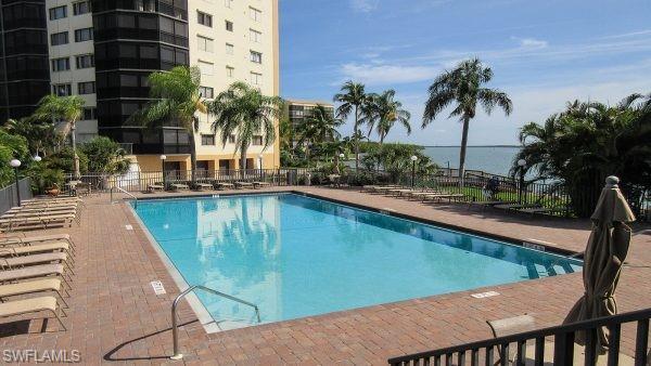Image 2: Community pool with a patio area