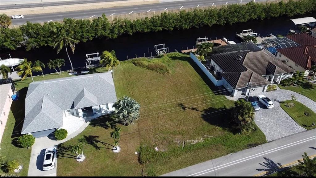 Image 3: Aerial view of property and surrounding area featuring a nearby body of water