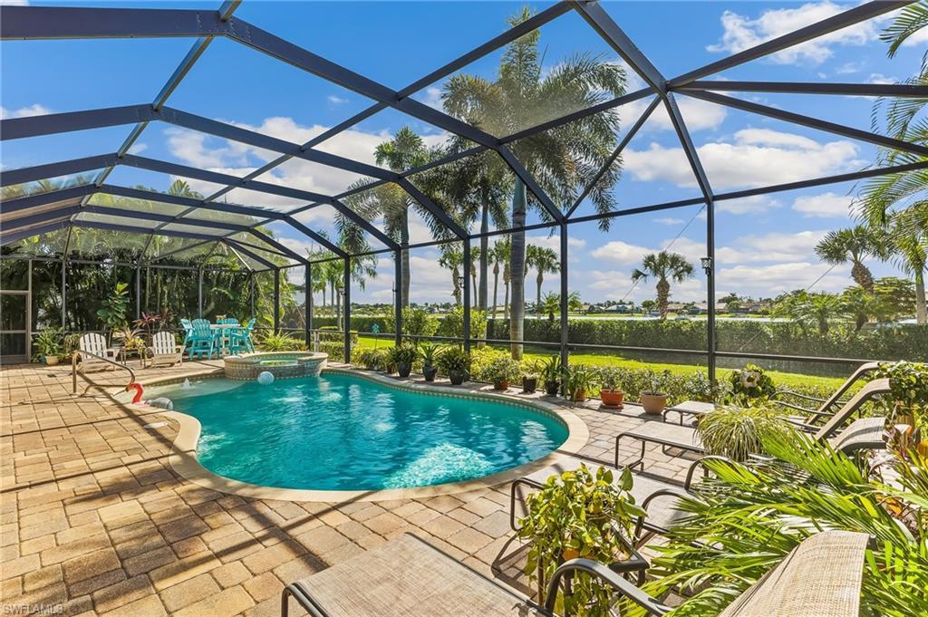 Image 1: Areca palms on both sides of lanai for privacy. Lanai spans width of house.