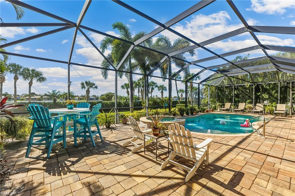 Image 3: Pool & Spa with expansive paver deck spanning width of home. Areca palms on sides for privacy.