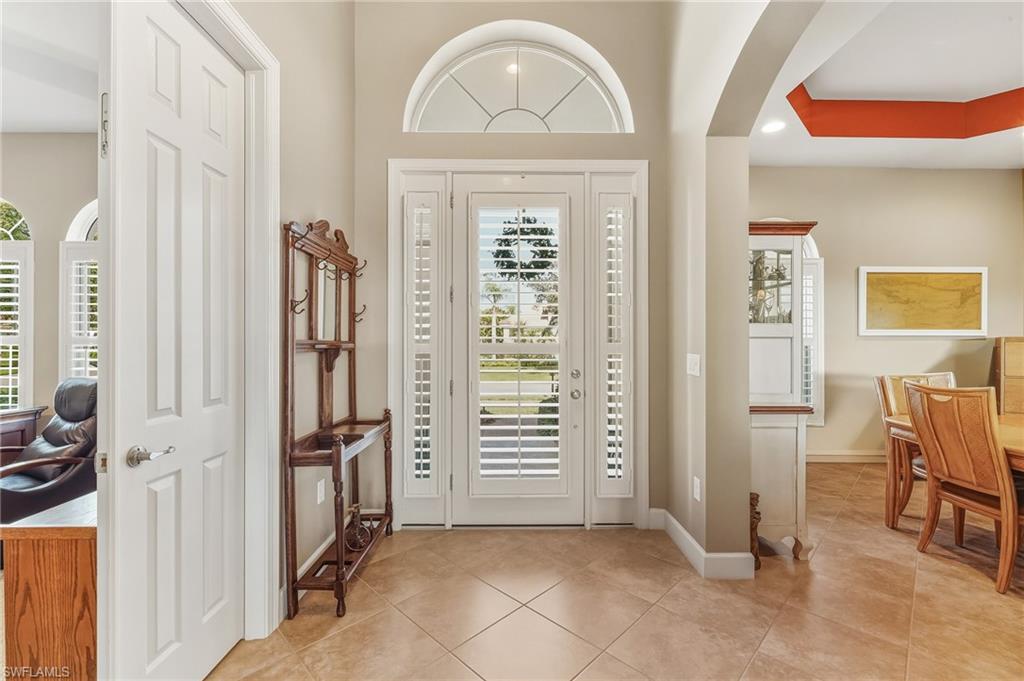 Image 4: Front door with glass inserts & transom window allows for more natural light.
