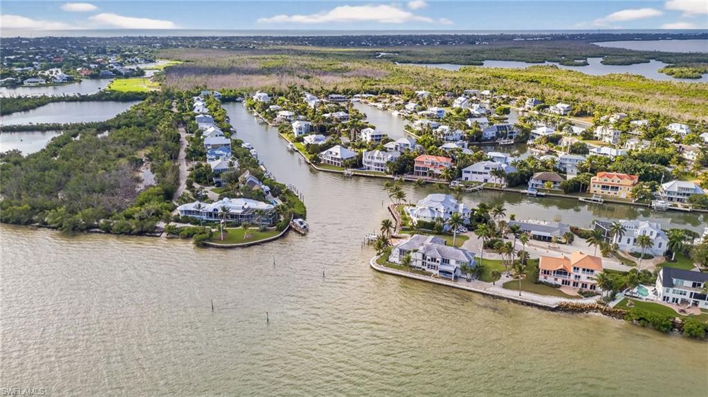 Image 2: Aerial perspective of suburban area with a nearby body of water