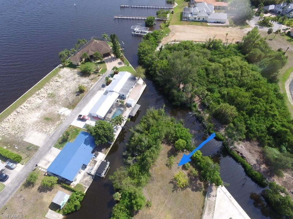 Image 3: Aerial view of property and surrounding area featuring a nearby body of water