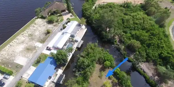 Image 3: Aerial view of property and surrounding area featuring a nearby body of water
