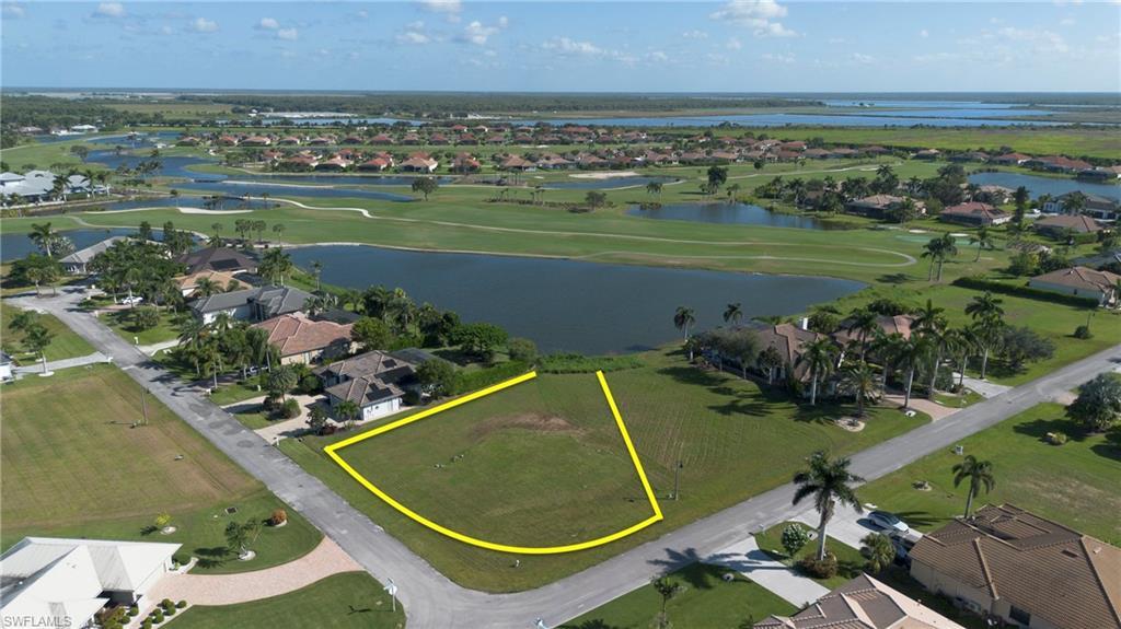 Image 3: Aerial view of residential property boundaries highlighted, and overview of golf course and lake