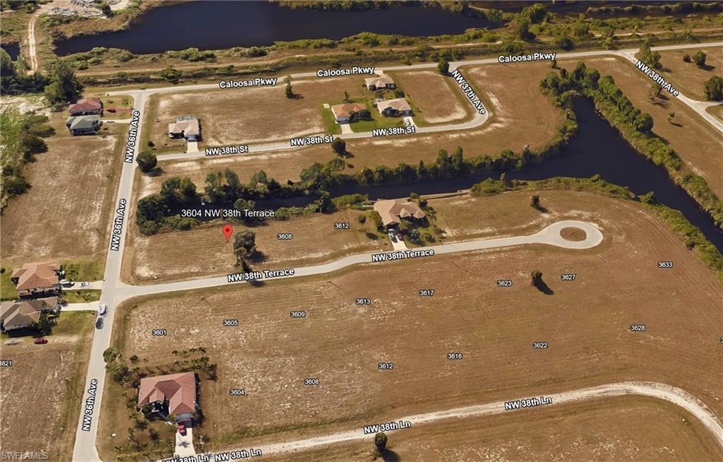 Image 2: View of property location featuring a nearby body of water and nearby suburban area