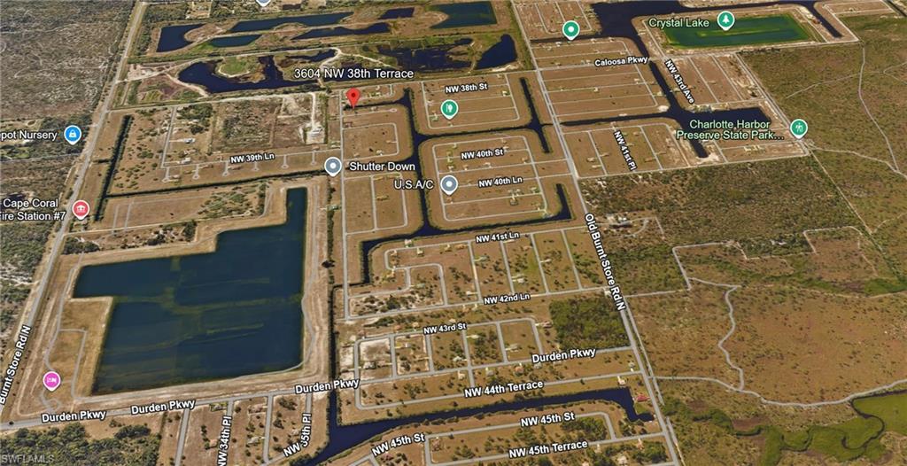 Image 3: Aerial view of residential area featuring a nearby body of water