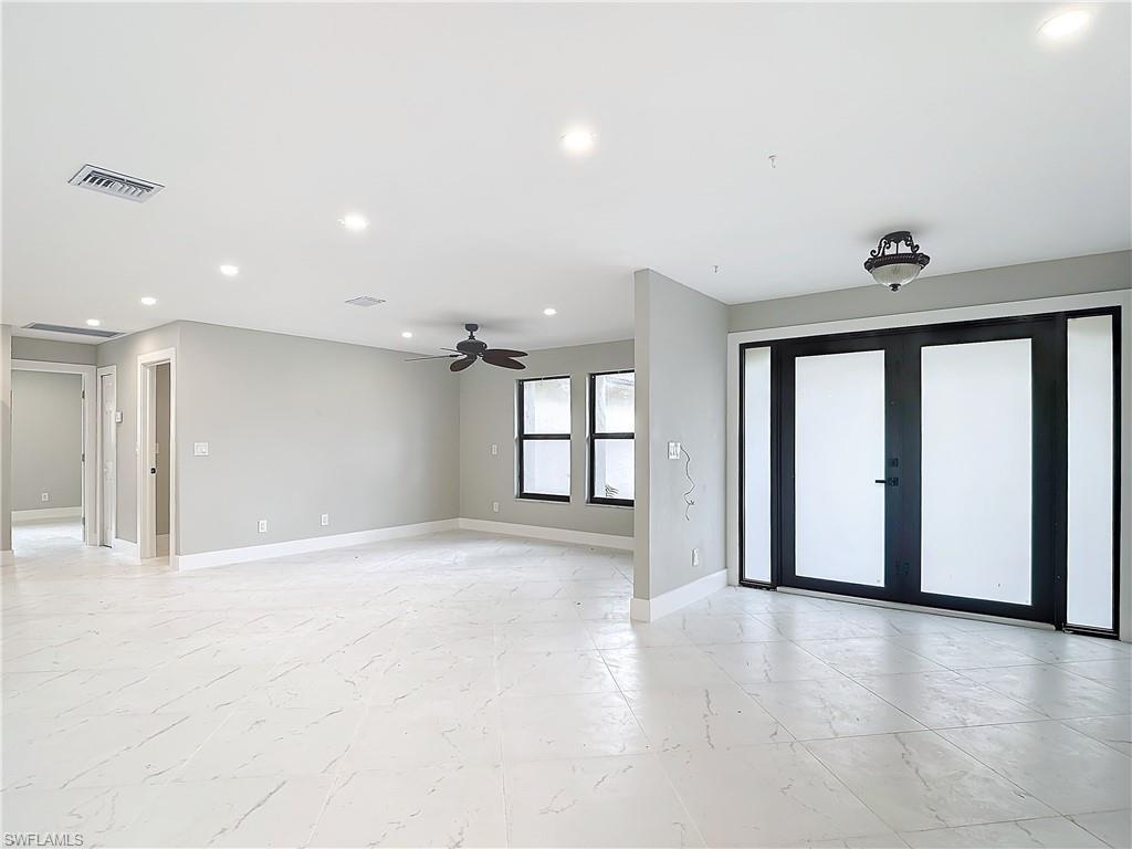Image 2: Unfurnished room featuring french doors, light tile flooring, and ceiling fan
